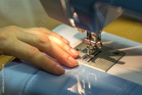 Fototapeta Naklejka Na Ścianę i Meble -  close up mechanism of sewing machine foot  with needle and thread