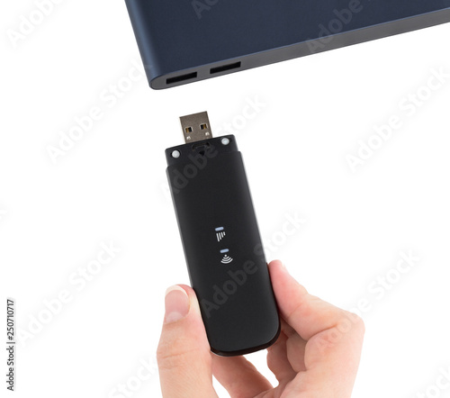Portable usb modem and hand on a white background. Connect 4g / lte modem to a laptop.
