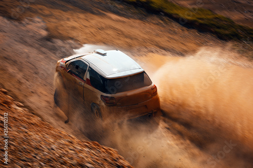 Rally vehicle going fast with mud and water splash