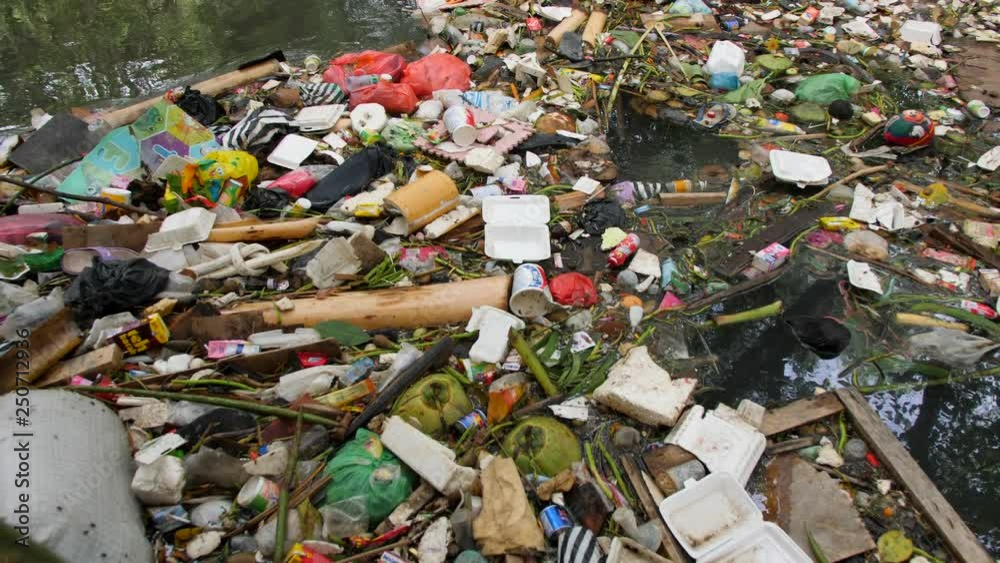 Huge Dump in Tropical Mangrove Tree Forest. Plastic Waste Rubbish Floating in Lake Water. Environmental Pollution Ecological Problem Concept. 4K. Bali, Indonesia. Huge Dump in Tropical Mangrove Tree Forest. Plastic Waste Rubbish Floating in Lake Water. Environmental Pollution Ecological Problem Concept. 4K. Bali, Indonesia.