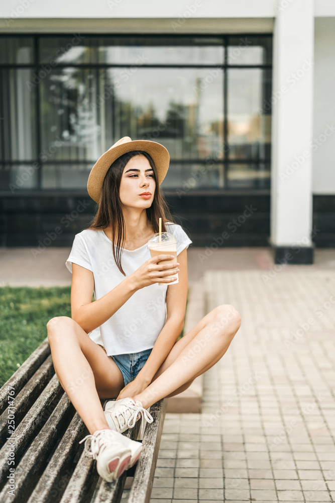 Brunette pretty tourist girl outdoor with cup of cold coffee. Brunette pretty tourist girl outdoor with cup of cold coffee.