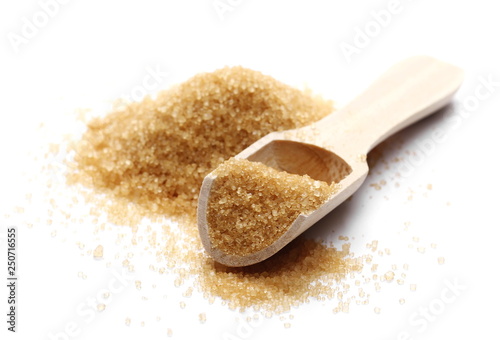 Brown cane sugar pile in wooden spoon isolated on white background, sugarcane texture