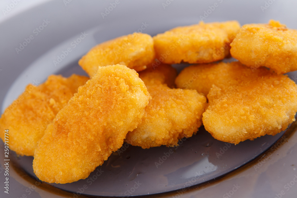 Chicken nuggets with cheese on a glass plate. Chicken nuggets with cheese on a glass plate.