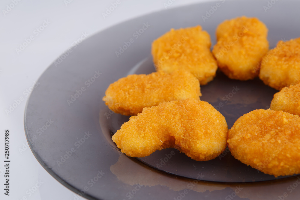 Chicken nuggets with cheese on a glass plate. Chicken nuggets with cheese on a glass plate.