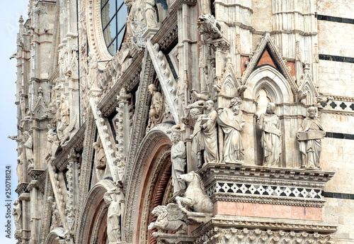 Great example of Italian architecture of the 14th century, facade of Duomo di Siena with sculptures and reliefs, Tuscan. UNESCO World Heritage Site