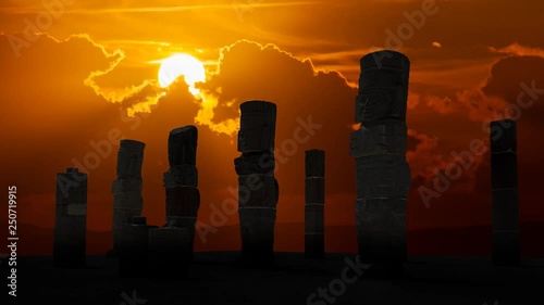 Atlantean columns or Toltec warriors on Pyramid of Quetzalcoatl in Ancient ruins of Tula de Allende, Sunset time lapse in Mesoamerican archeological site, capital of the Toltec Empire, Mexico photo