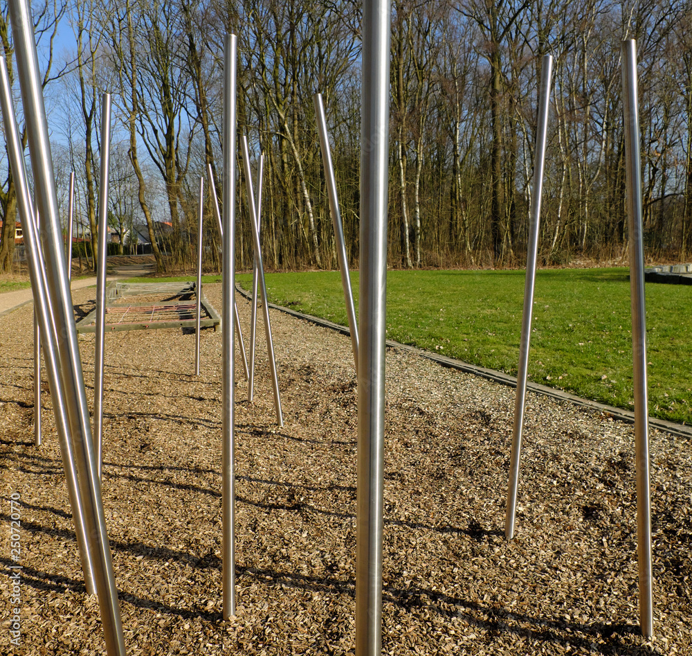 Fototapeta premium Part of obstacle course, parkour for children at the playground. Long metal sticks