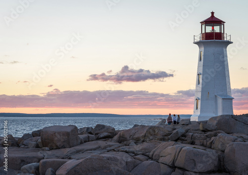 Three Women Watching Sunset at Peggy's Cove Lighthouse