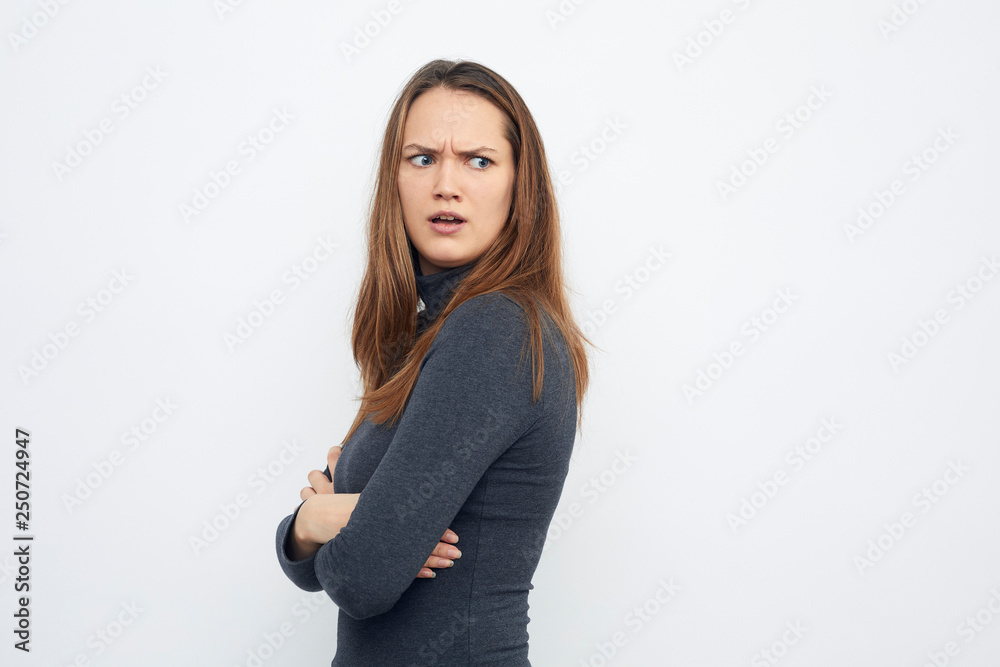 portrait of young woman looking mad over shoulder portrait of young woman looking mad over shoulder