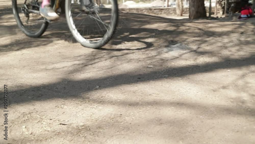 Detail of gravel road and bike wheel passing very fast. Dust in the air. Bike race in Londres, Catamarca Province, Argentina. Detail of gravel road and bike wheel passing very fast. Dust in the air. Bike race in Londres, Catamarca Province, Argentina.