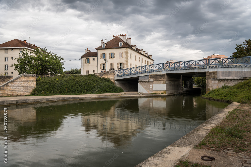 Bridge over canal in Dijon on a cloudy day in summer