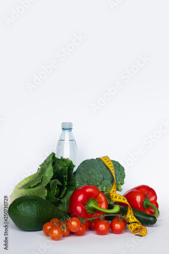 Healthy food for diet, vegetables with measurement tape on white background. Copy space