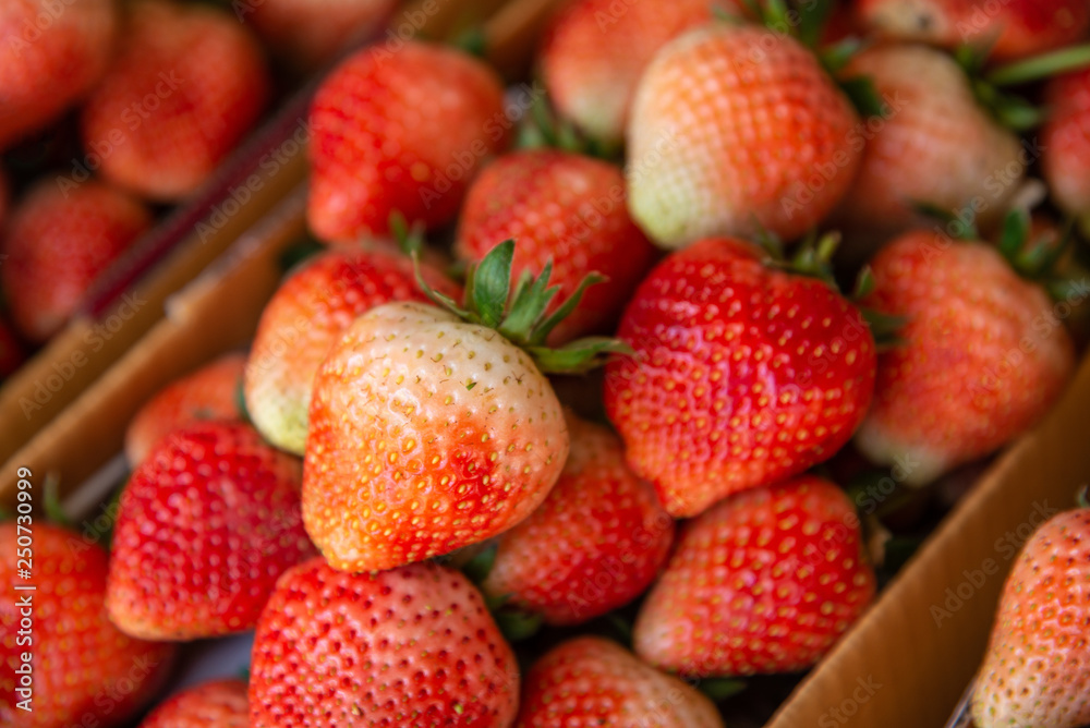 Fresh strawberries in paper boxes ready for sale at the market. Fresh strawberries in paper boxes ready for sale at the market.