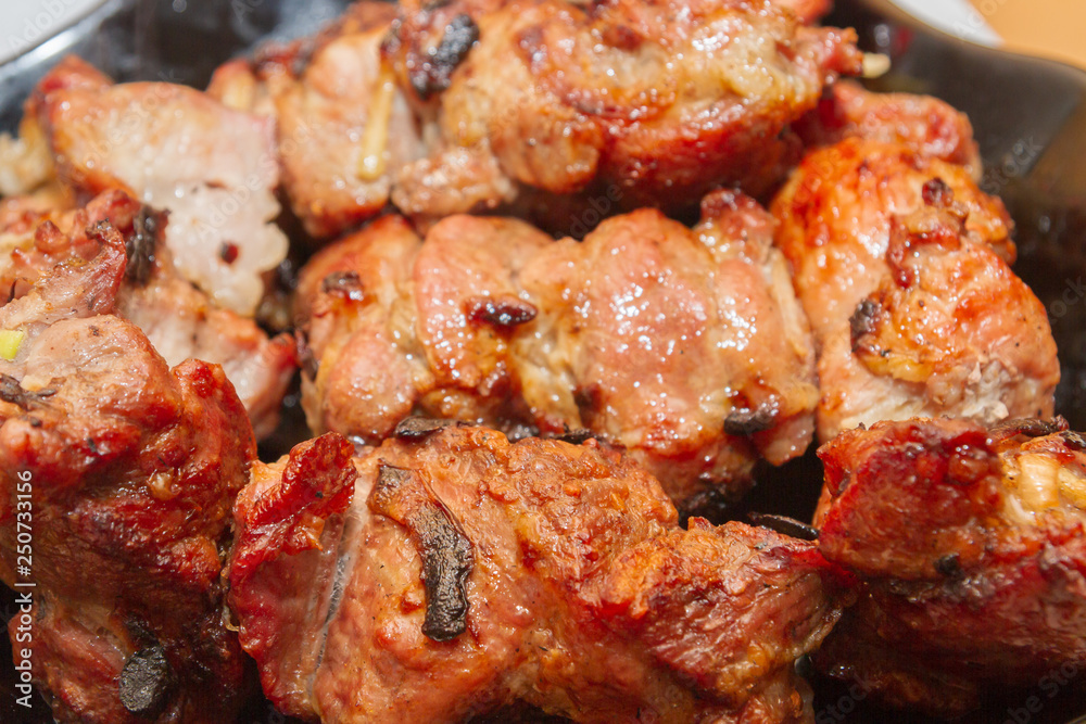 Delicious appetizing shish kebab of pork meat is in the plate Delicious appetizing shish kebab of pork meat is in the plate