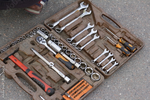 a set of tools in a box on asphalt