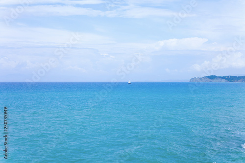Beautiful blue sea with blue sky background. Holiday concept image with blue sea