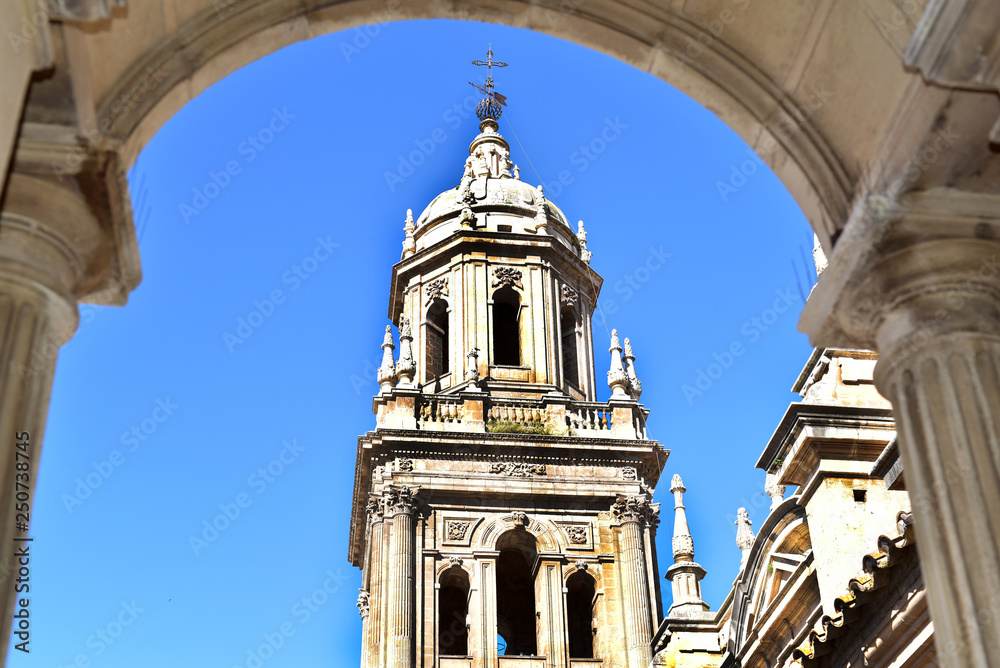 Fototapeta premium View out of a window in the cathedral to the tower and the mountains above Jaen, Jaen province, Andalusia, Spain