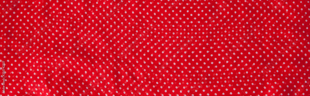 Red fabric with the white polka dots as a background texture composition Red fabric with the white polka dots as a background texture composition