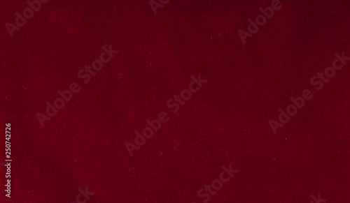 Close up of red velvet paper with embossed flowers