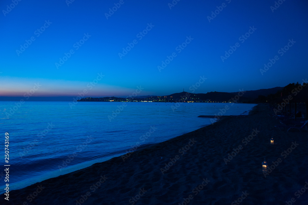 blue sea at sunset with island and moon