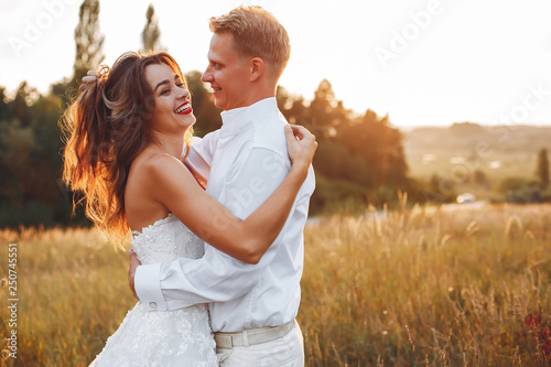 Beautiful wedding couple in a summer field