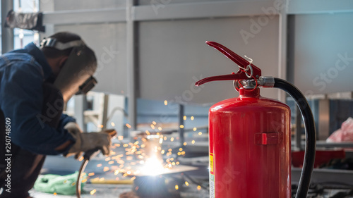Fire extinguisher are used to prevent fire in welding steel work. photo