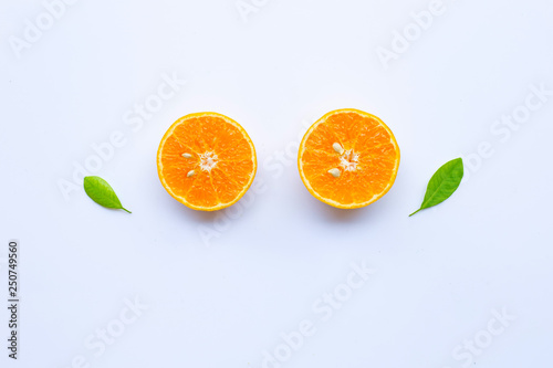 High vitamin C. Fresh orange citrus fruit with leaves isolated on white.