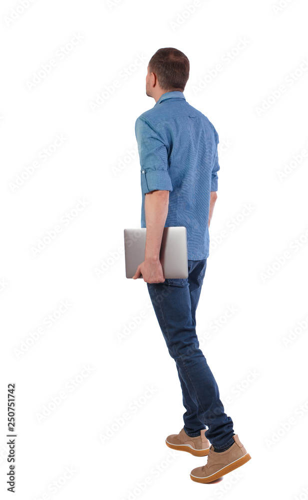Back view of a walking man with a laptop. Back view of a walking man with a laptop.