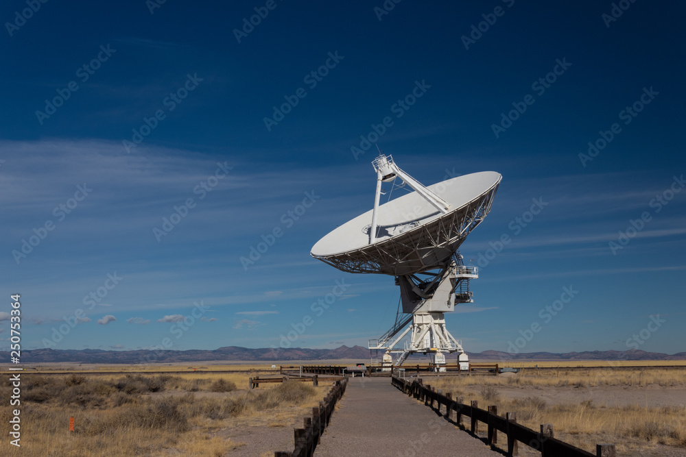 Very Large Array path to a radio antenna dish of the VLA in the New Mexico desert, space astronomy technology, horizontal aspect