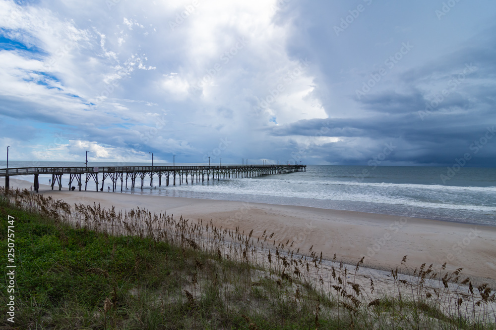 Ocean pier in stormy skies