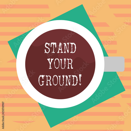 Word writing text Stand Your Ground. Business concept for maintain ones position typically in face of opposition Top View of Drinking Cup Filled with Beverage on Color Paper photo photo