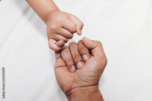 Closeup of kids hand into parents hands. Family concept