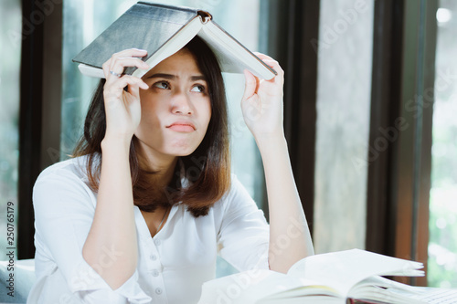 Asia woman reading book with boring. photo