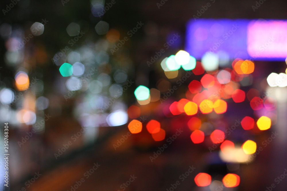 Blurred image of night life in the city. Traffic light bokeh in twilight time.