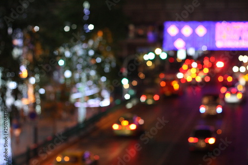 Blurred image of night life in the city. Traffic light bokeh in twilight time.