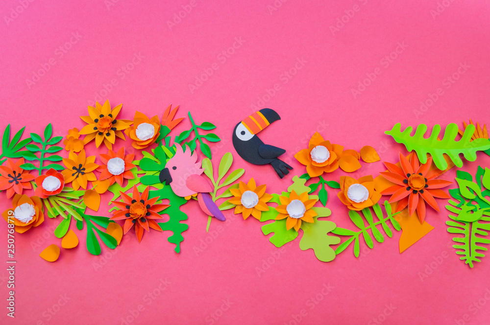 Creative setting. The process of cutting leaves and flowers from paper. Tropics exotic jungle.