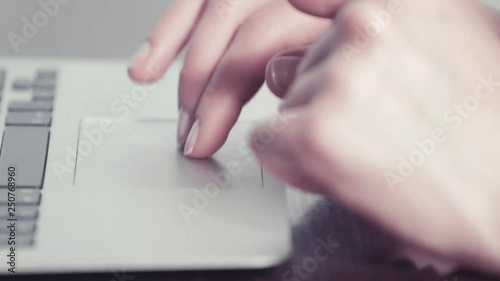 Woman clicking on trackpad laptop 