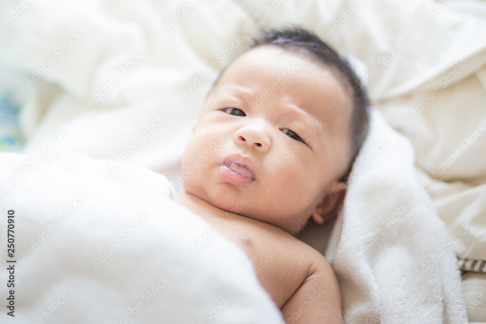 Asian baby boy lying on white blanket morning wake up Asian baby boy lying on white blanket morning wake up