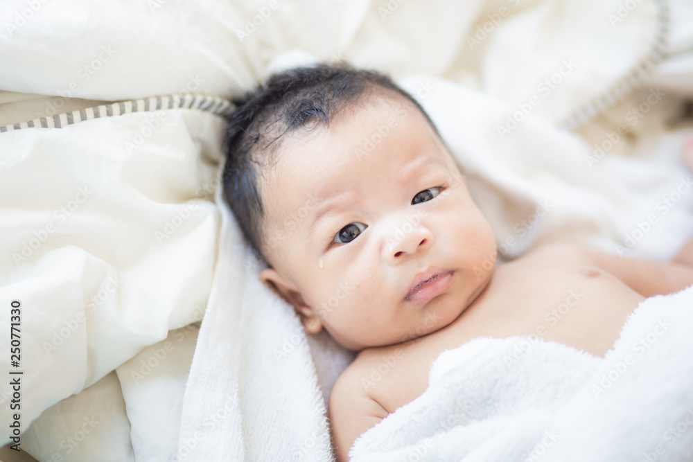 Asian baby boy lying on white blanket morning wake up Asian baby boy lying on white blanket morning wake up