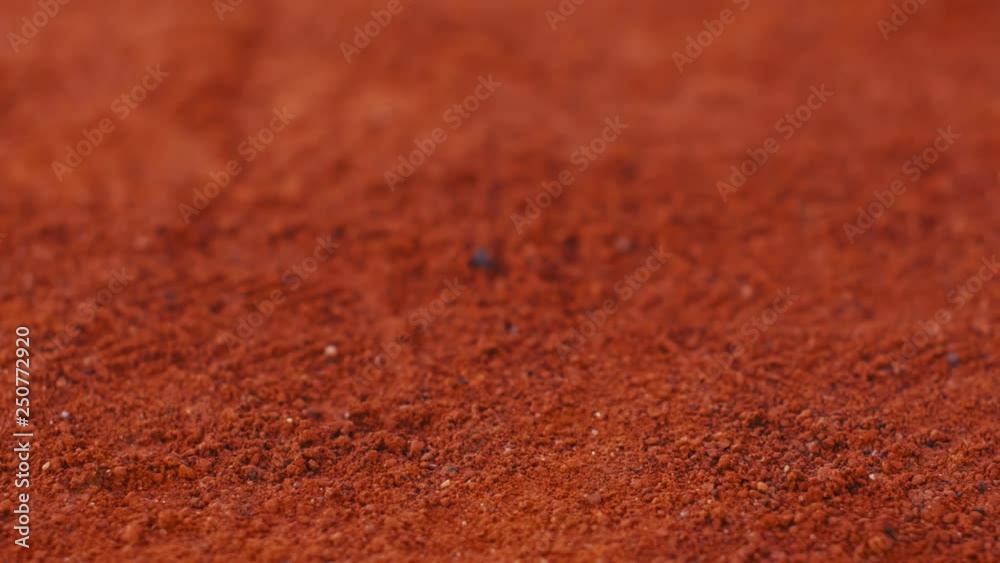 Tennis player bouncing tennis ball on a red tennis court before serving. 180fps Tennis player bouncing tennis ball on a red tennis court before serving. 180fps