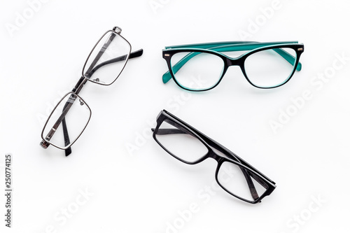 Set of glasses with transparent lenses on white background top view