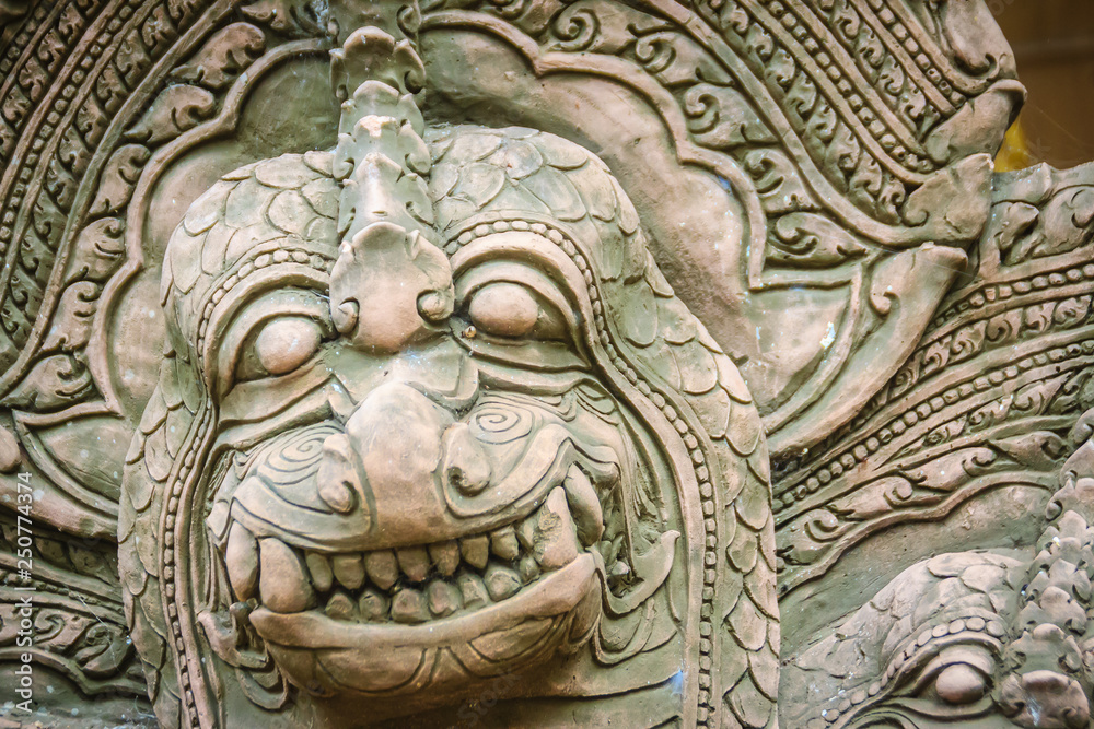 Khmer' s style Naga head made from sand stone at the public temple in Thailand. Naga or large snake according to Hindu belief.