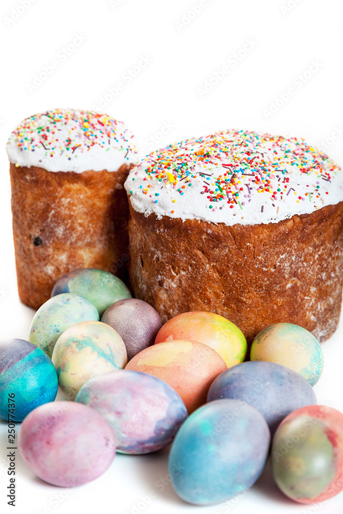 Two Easter cakes and colorful eggs on white background Two Easter cakes and colorful eggs on white background