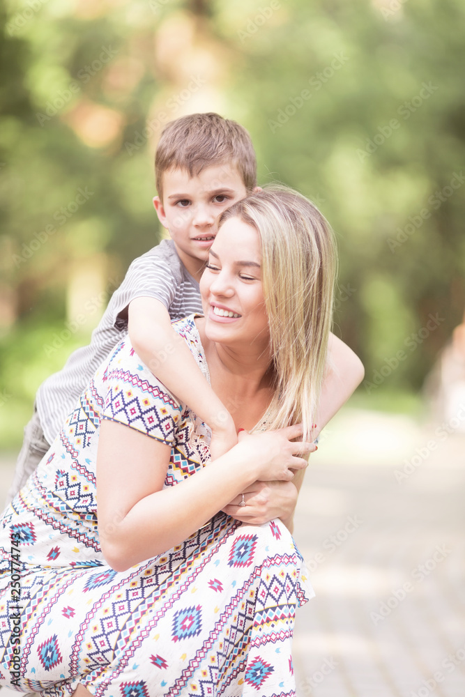 Fototapeta premium Mother and son outdoors in park
