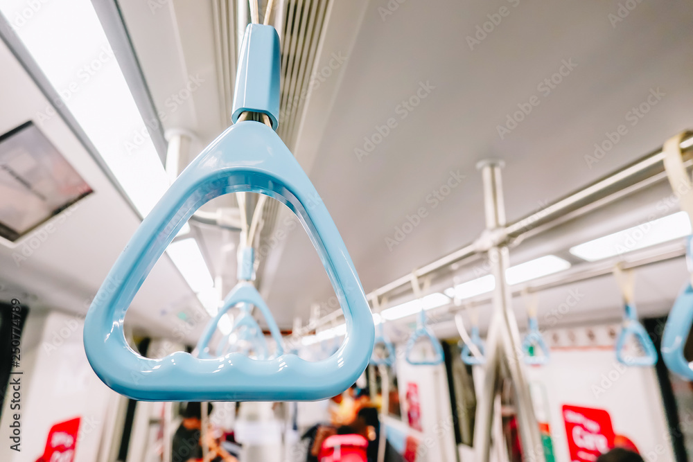 Handrails in a metro subway car , Handle or hand straps in MRT for the safety of passenger,Focus on a handrail.