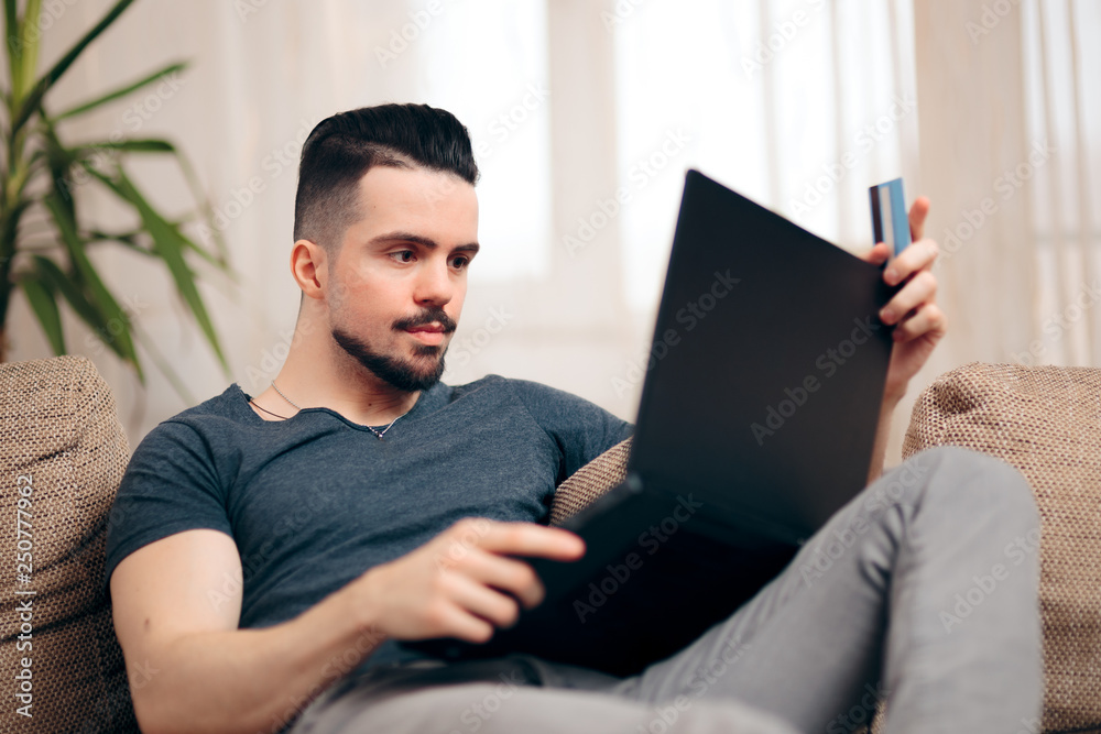 Man Sitting on a Couch Using His Laptop Man Sitting on a Couch Using His Laptop