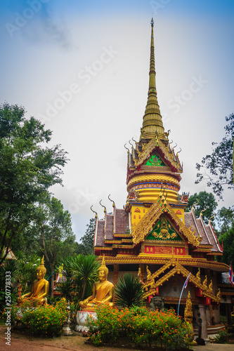 Beautiful golden pagoda with decorative Thai style fine art at public Buddhist Wat Phu Phlan Sung temple, Nachaluay, Ubon Ratchathani, Thailand.