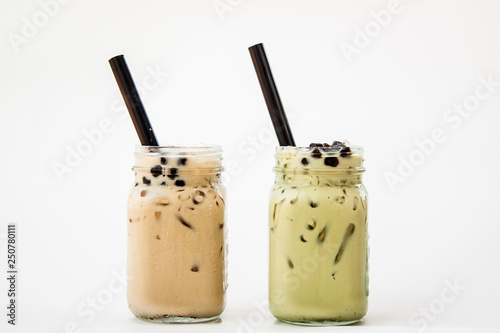 Glass of Iced milke tea and Iced milk green tea with bubble boba the fresh cold drink on white background  photo