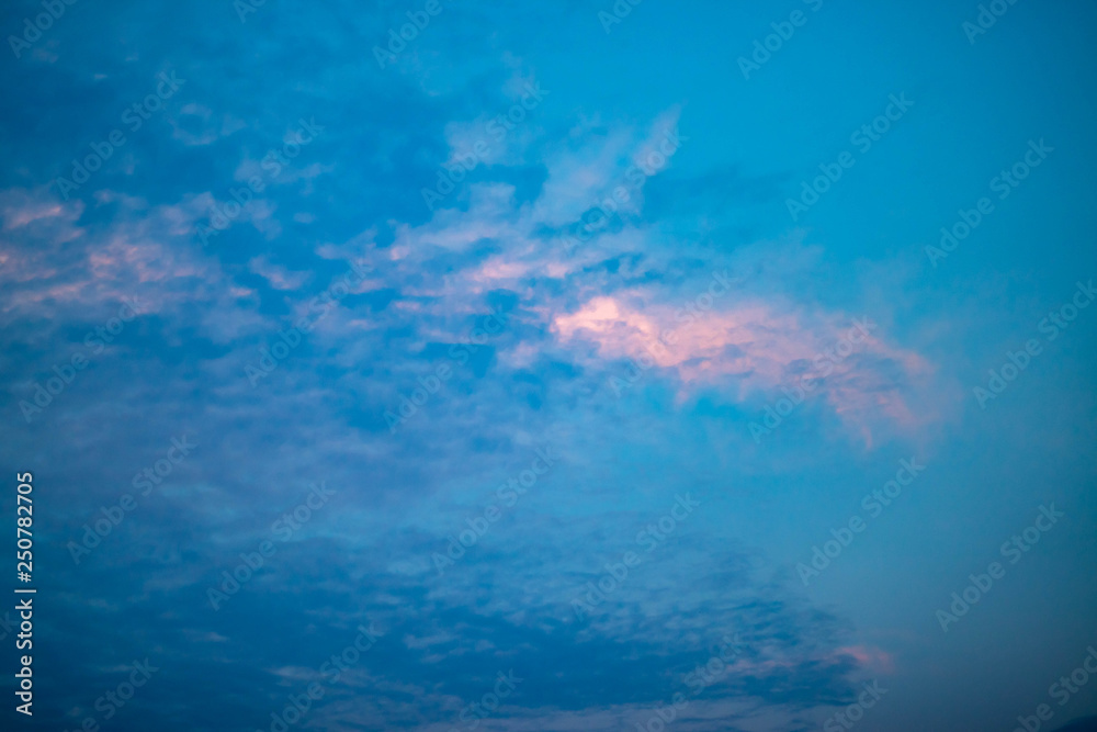 Sky with gray cloud and white clouds floating over the sun causing reflection Orange light at some clouds causing beauty of the sky in the evening. Sky with gray cloud and white clouds floating over the sun causing reflection Orange light at some clouds causing beauty of the sky in the evening.