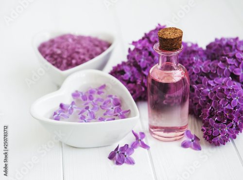 Essential oil and sea salt with lilac flowers